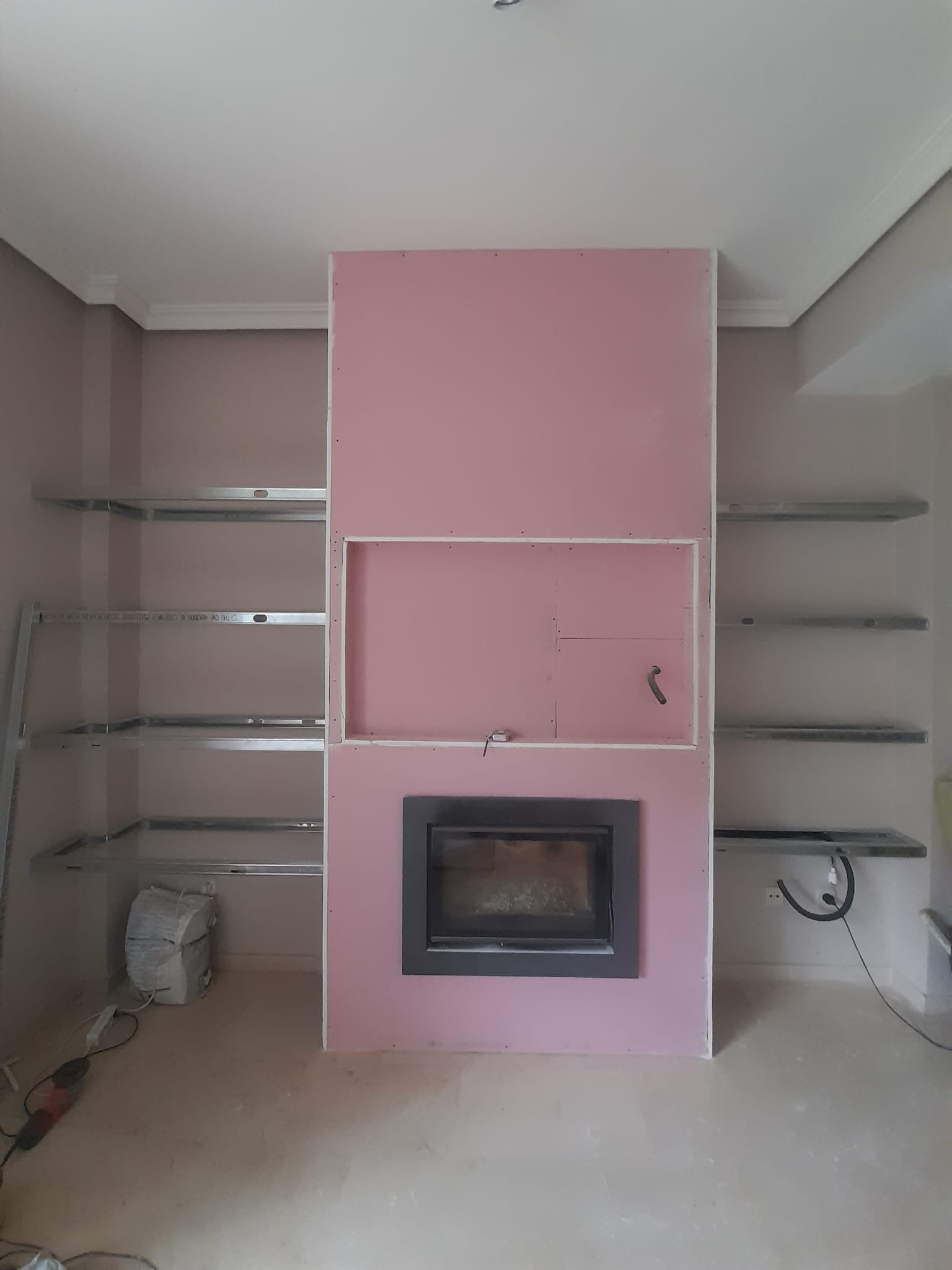 Fireplace with a TV and a library decoration