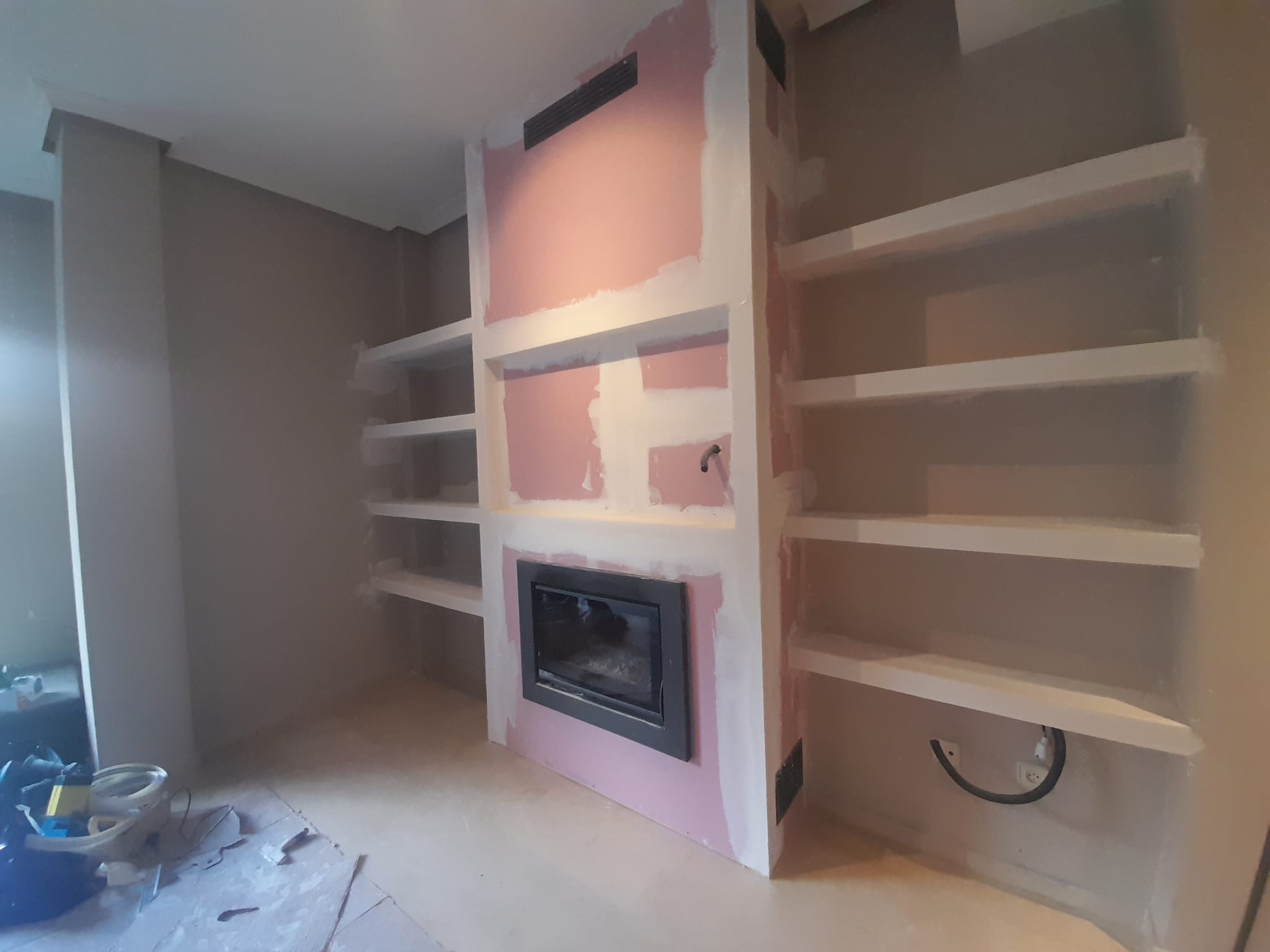 Fireplace with a TV and a library decoration